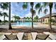 Relax by the sparkling community pool with fun water features and lounge chairs under the shade of palm trees at 2816 Ivy Lake Ct, Lakeland, FL 33811