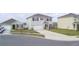 A pristine two-story home boasts a manicured lawn, a spacious two-car garage and a concrete driveway at 2816 Ivy Lake Ct, Lakeland, FL 33811
