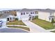 Two-story home features manicured landscaping, a two car garage and a lengthy concrete driveway at 2816 Ivy Lake Ct, Lakeland, FL 33811