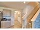 Hallway with tile flooring, stairs with baby gate, and kitchen counter view on the left at 2816 Ivy Lake Ct, Lakeland, FL 33811
