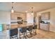 Modern kitchen features a granite island with barstool seating and stainless steel appliances at 2816 Ivy Lake Ct, Lakeland, FL 33811