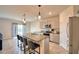 Eat-in kitchen features a granite island with seating and stainless steel appliances at 2816 Ivy Lake Ct, Lakeland, FL 33811