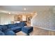 Open-concept living room with kitchen view and accent brick wall at 2816 Ivy Lake Ct, Lakeland, FL 33811