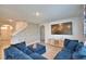 Cozy living room with blue sofa, mounted television, and decorative brick accent wall at 2816 Ivy Lake Ct, Lakeland, FL 33811