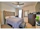 Comfortable main bedroom features a tufted headboard and a ceiling fan at 2816 Ivy Lake Ct, Lakeland, FL 33811