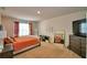 Spacious primary bedroom featuring plush carpet, dresser and a television at 2816 Ivy Lake Ct, Lakeland, FL 33811