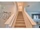 Carpeted staircase with white railing and Gathering-themed wall decor leading to the second floor at 2816 Ivy Lake Ct, Lakeland, FL 33811