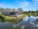 Beautiful backyard view of home on water, enhanced by a lovely screened in lanai at 2859 Medinah Cir, Lakeland, FL 33803