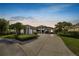 Beautiful single-Gathering home boasts a lush lawn and a well-manicured garden, enhancing its curb appeal at 2859 Medinah Cir, Lakeland, FL 33803