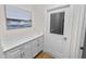 Laundry room features a marble countertop, under cabinet storage, and backyard access at 2859 Medinah Cir, Lakeland, FL 33803