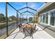 Screened-in patio overlooking the lake with a dining table and chairs at 2859 Medinah Cir, Lakeland, FL 33803