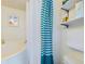 Small bathroom with shower/tub combo, teal striped curtain, and white shelves at 2907 Marion Way # 2907, Haines City, FL 33844