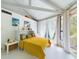 Bright bedroom with yellow bedspread, high ceilings, and sliding glass doors at 2907 Marion Way # 2907, Haines City, FL 33844