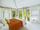 Bedroom with orange bedding and leafy views at 2907 Marion Way # 2907, Haines City, FL 33844