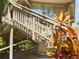 Elevated home's entrance with wooden stairs and landscaping at 2907 Marion Way # 2907, Haines City, FL 33844