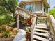 Elevated home with wooden stairs and tropical plants at 2907 Marion Way # 2907, Haines City, FL 33844