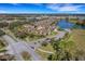 Wide aerial view of the neighborhood, featuring a pond and well-maintained landscaping around the yellow homes at 3019 Mission Lakes Dr, Lakeland, FL 33803