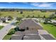 Beautiful aerial shot showcasing the rear of a well-maintained yellow home with a vast green space in the background at 3019 Mission Lakes Dr, Lakeland, FL 33803