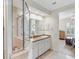 Bright bathroom featuring double sinks, granite countertops, and glass enclosed shower with access to the bedroom at 3019 Mission Lakes Dr, Lakeland, FL 33803