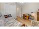Bedroom featuring wood floors, a ceiling fan, and a large closet with white doors and an office desk at 3019 Mission Lakes Dr, Lakeland, FL 33803