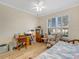 Bedroom featuring wood floors, a ceiling fan, plantation shutters, and an office area at 3019 Mission Lakes Dr, Lakeland, FL 33803