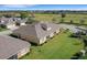 Lovely aerial view of a single story home with a well-manicured lawn and screened-in porch overlooking a green space at 3019 Mission Lakes Dr, Lakeland, FL 33803