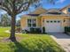 Attached one car garage with a well-maintained lawn and mature landscaping at 3019 Mission Lakes Dr, Lakeland, FL 33803