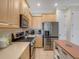 Bright kitchen featuring stainless steel appliances and an island cart at 3019 Mission Lakes Dr, Lakeland, FL 33803