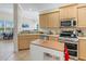 Open concept kitchen with stainless steel appliances, a center island, and views into the living spaces at 3019 Mission Lakes Dr, Lakeland, FL 33803