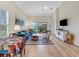 Open-concept living room with hardwood floors and a sliding glass door at 3019 Mission Lakes Dr, Lakeland, FL 33803