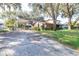 Exterior shot of the home with a long driveway leading to the house at 306 Estrella Way, Auburndale, FL 33823