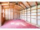 Shed interior with exposed rafters and built-in shelving at 306 Estrella Way, Auburndale, FL 33823