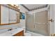 Bathroom featuring a shower with sliding glass doors, a wood vanity, and matching framed mirror at 3437 Kathy Ct, Lakeland, FL 33810