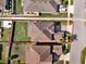 Aerial view showcases the property's layout, including the roof, lawn, and proximity to neighboring homes at 3460 Canvas St, Kissimmee, FL 34741