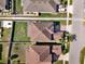 Aerial view showcases the property's layout, including the roof, lawn, and proximity to neighboring homes at 3460 Canvas St, Kissimmee, FL 34741