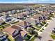 Aerial view of homes displaying neighborhood layout, landscaping, and proximity to community features at 3460 Canvas St, Kissimmee, FL 34741