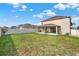 Large backyard featuring well-maintained lawn, fence, covered patio, and outdoor space at 3460 Canvas St, Kissimmee, FL 34741