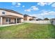 Expansive backyard with healthy lawn, secure fence, covered patio with ceiling fan, and ample space at 3460 Canvas St, Kissimmee, FL 34741