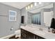 Bathroom featuring white counters, grey walls, and a shower with blue curtain at 3460 Canvas St, Kissimmee, FL 34741