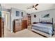 Bedroom with grey walls, neutral carpet, ceiling fan, a dresser, and queen-size bed at 3460 Canvas St, Kissimmee, FL 34741