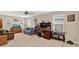 Well lit bonus room with a sofa, dresser with television, and a desk at 3460 Canvas St, Kissimmee, FL 34741