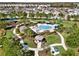 Aerial shot of a kidney-shaped community pool and surrounding lounge area, gazebo, and playground at 3460 Canvas St, Kissimmee, FL 34741