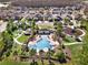 Aerial perspective of a kidney-shaped community pool and surrounding lounge area with playground at 3460 Canvas St, Kissimmee, FL 34741