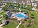 Aerial perspective of a kidney-shaped community pool and surrounding lounge area with playground at 3460 Canvas St, Kissimmee, FL 34741