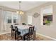 Cozy dining area with neutral decor, a view into the kitchen, and natural light from the window at 3460 Canvas St, Kissimmee, FL 34741