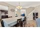Bright dining area with a table that seats six, lovely chandelier, and access to other rooms at 3460 Canvas St, Kissimmee, FL 34741