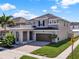 Charming two-story home featuring a brick driveway, a two-car garage, and well-maintained landscaping at 3460 Canvas St, Kissimmee, FL 34741
