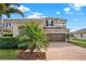 Charming two-story home featuring a brick driveway, a two-car garage, and well-maintained landscaping at 3460 Canvas St, Kissimmee, FL 34741