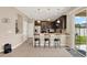Modern eat-in kitchen features dark wood cabinets, stainless steel appliances, and counter seating at 3460 Canvas St, Kissimmee, FL 34741