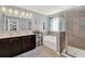 This primary bathroom features a double vanity, soaking tub, and glass-enclosed shower at 3460 Canvas St, Kissimmee, FL 34741